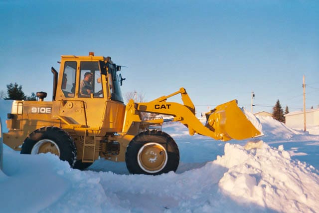 A loader clearing deep snow